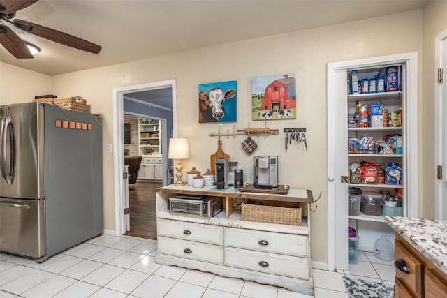 1076 N Cedar St, Muenster, TX 76252 - kitchen with baseboards, freestanding refrigerator, ceiling fan, and light tile patterned flooring