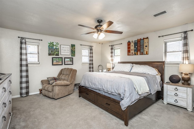 1076 N Cedar St, Muenster, TX 76252 - bedroom featuring visible vents, baseboards, ceiling fan, and light carpet