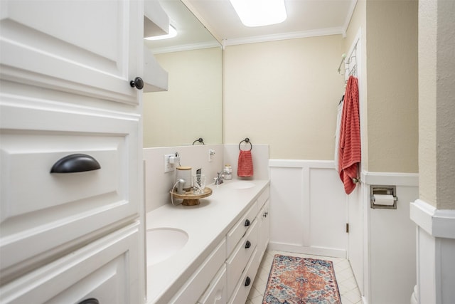 1076 N Cedar St, Muenster, TX 76252 - full bath featuring double vanity, tile patterned flooring, a sink, a wainscoted wall, and ornamental molding