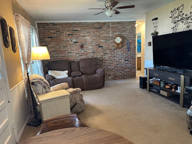 carpeted living area featuring a ceiling fan and brick wall