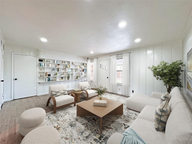 2136 Van Cleave Dr, Dallas, TX 75216 - living area with recessed lighting, a decorative wall, and wood finished floors