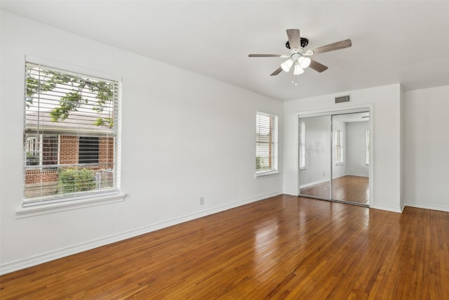 2136 Van Cleave Dr, Dallas, TX 75216 - unfurnished bedroom featuring a ceiling fan, baseboards, wood finished floors, visible vents, and a closet
