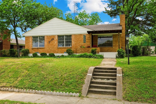 2136 Van Cleave Dr, Dallas, TX 75216 - view of front of house featuring brick siding, fence, a chimney, and a front lawn