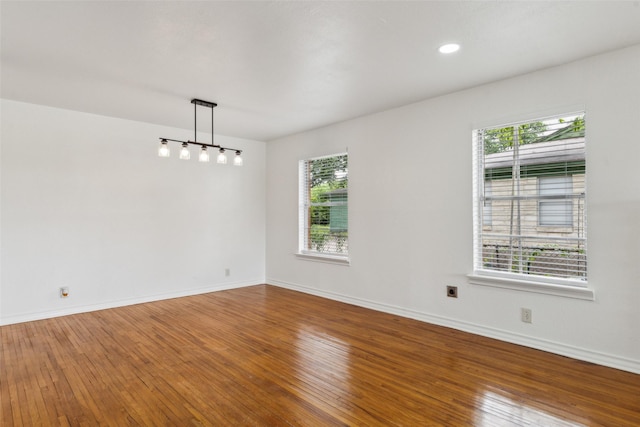 2136 Van Cleave Dr, Dallas, TX 75216 - empty room with plenty of natural light, baseboards, and hardwood / wood-style floors