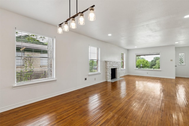 2136 Van Cleave Dr, Dallas, TX 75216 - unfurnished living room with wood-type flooring, recessed lighting, baseboards, and a fireplace with flush hearth