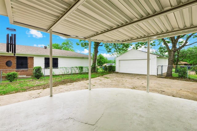 2136 Van Cleave Dr, Dallas, TX 75216 - view of patio featuring a detached garage, fence, and an outbuilding