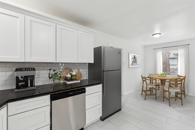 2136 Van Cleave Dr, Dallas, TX 75216 - kitchen featuring stainless steel appliances, baseboards, white cabinetry, and tasteful backsplash