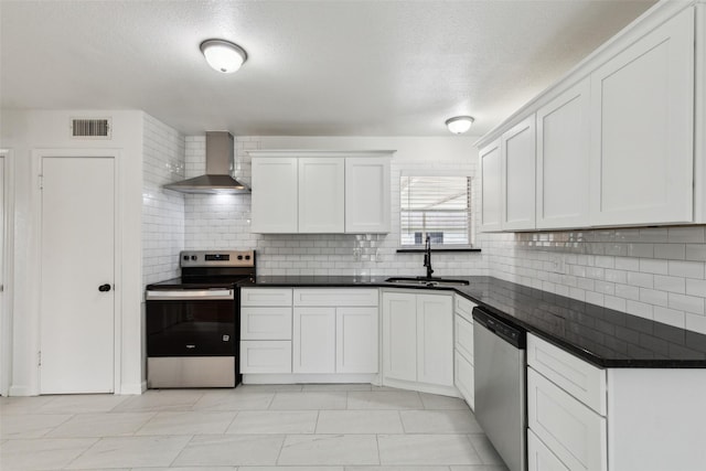 2136 Van Cleave Dr, Dallas, TX 75216 - kitchen with visible vents, wall chimney range hood, a sink, backsplash, and stainless steel appliances