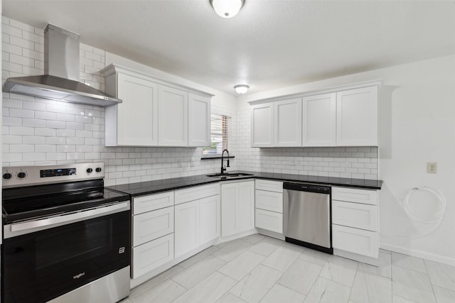 2136 Van Cleave Dr, Dallas, TX 75216 - kitchen with wall chimney range hood, appliances with stainless steel finishes, tasteful backsplash, dark countertops, and a sink