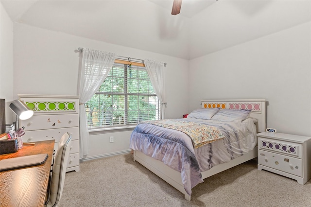 bedroom featuring light carpet, a ceiling fan, and lofted ceiling