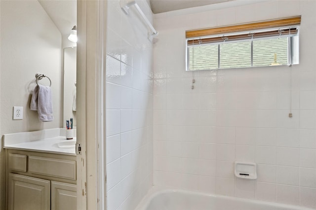 bathroom featuring washtub / shower combination, a healthy amount of sunlight, and vanity