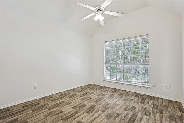empty room featuring wood finished floors, a ceiling fan, baseboards, and lofted ceiling