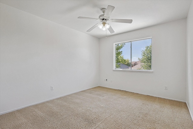 empty room featuring a ceiling fan, baseboards, and light carpet
