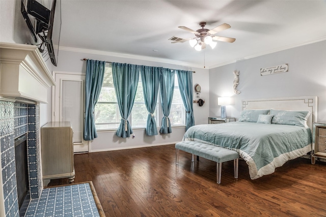10228 Crawford Farms Dr, Fort Worth, TX 76244 - bedroom featuring a tiled fireplace, crown molding, wood finished floors, baseboards, and a ceiling fan