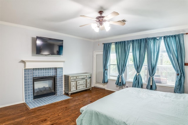 10228 Crawford Farms Dr, Fort Worth, TX 76244 - bedroom with crown molding, multiple windows, wood finished floors, baseboards, and a fireplace