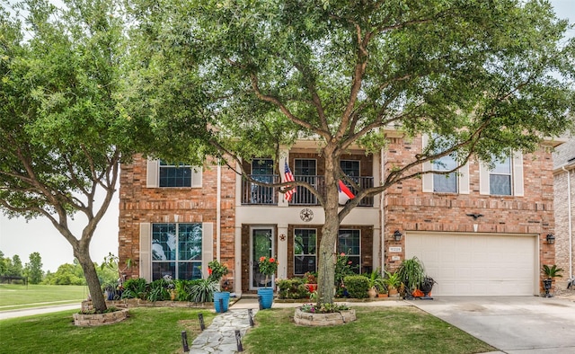 10228 Crawford Farms Dr, Fort Worth, TX 76244 - view of property featuring a balcony, a front lawn, driveway, an attached garage, and brick siding