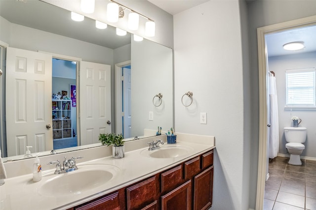 10228 Crawford Farms Dr, Fort Worth, TX 76244 - bathroom featuring tile patterned floors, double vanity, toilet, and baseboards