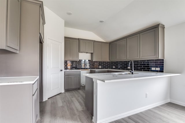3510 Middlefield Rd, Dallas, TX 75253 - kitchen with light wood-type flooring, a peninsula, gray cabinetry, and lofted ceiling