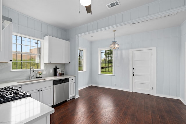2124 21st St, Fort Worth, TX 76164 - kitchen with stainless steel dishwasher, a sink, dark wood-style flooring, light countertops, and ceiling fan