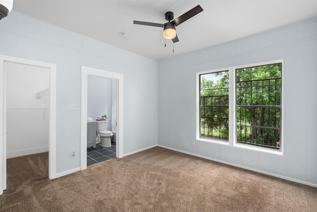 2124 21st St, Fort Worth, TX 76164 - unfurnished bedroom featuring carpet, a spacious closet, connected bathroom, baseboards, and a closet