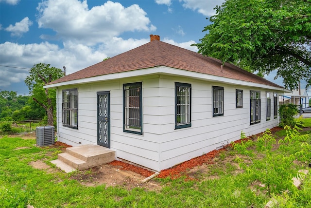 2124 21st St, Fort Worth, TX 76164 - back of house featuring central air condition unit and a chimney