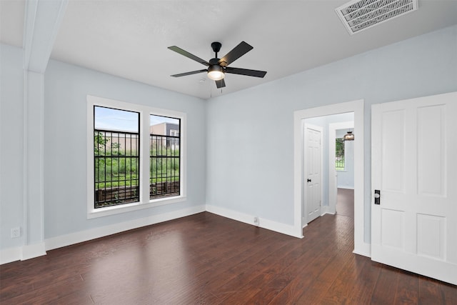 2124 21st St, Fort Worth, TX 76164 - spare room featuring healthy amount of natural light, baseboards, dark wood-style flooring, and a ceiling fan
