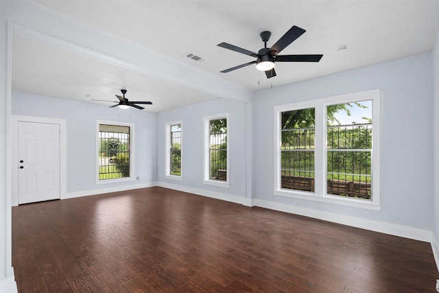 2124 21st St, Fort Worth, TX 76164 - unfurnished living room featuring ceiling fan, baseboards, and dark wood finished floors