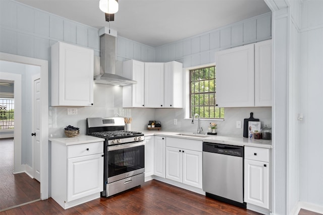 2124 21st St, Fort Worth, TX 76164 - kitchen featuring stainless steel appliances, wall chimney exhaust hood, a sink, dark wood-type flooring, and light countertops