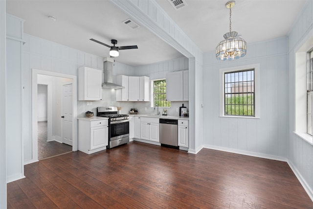 2124 21st St, Fort Worth, TX 76164 - kitchen featuring appliances with stainless steel finishes, wall chimney exhaust hood, light countertops, and dark wood finished floors
