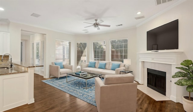 708 Renaissance Ct, Keller, TX 76248 - living room featuring wood finished floors, a fireplace, crown molding, visible vents, and ceiling fan