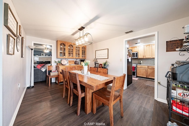 3756 County Road 192, Anson, TX 79501 - dining area featuring baseboards, dark wood finished floors, visible vents, and a fireplace