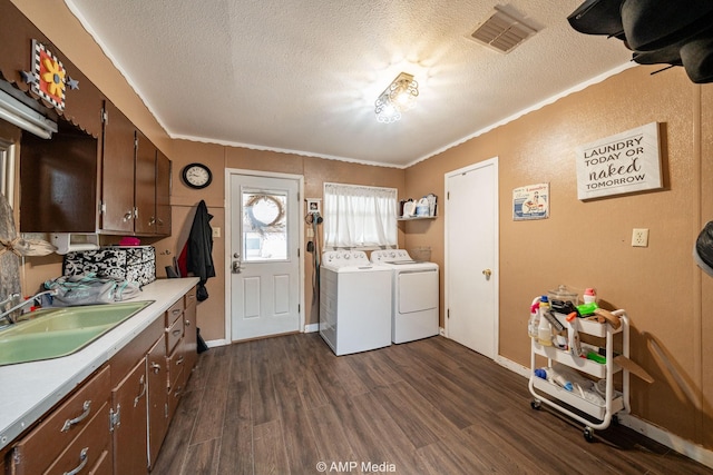 3756 County Road 192, Anson, TX 79501 - laundry area with cabinet space, a textured ceiling, dark wood-type flooring, visible vents, and washer and clothes dryer