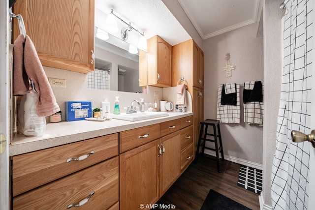 3756 County Road 192, Anson, TX 79501 - full bath with crown molding, visible vents, a textured wall, vanity, and wood finished floors