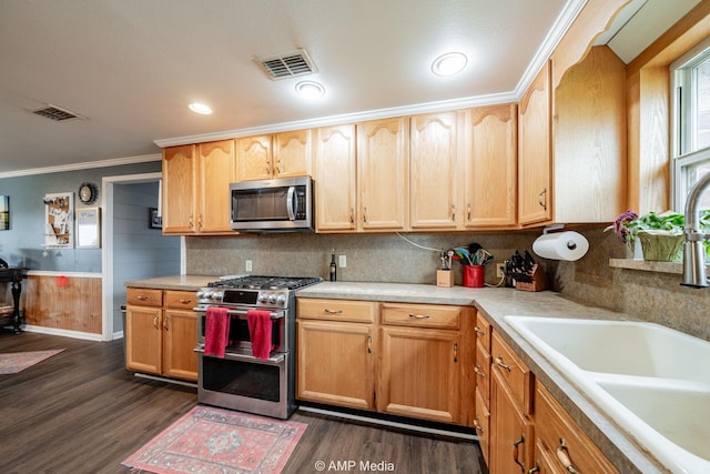 3756 County Road 192, Anson, TX 79501 - kitchen featuring visible vents, dark wood finished floors, a sink, ornamental molding, and stainless steel appliances