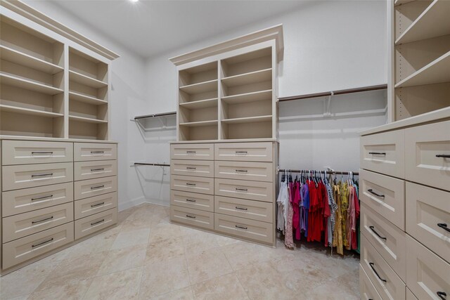spacious closet with light tile patterned floors