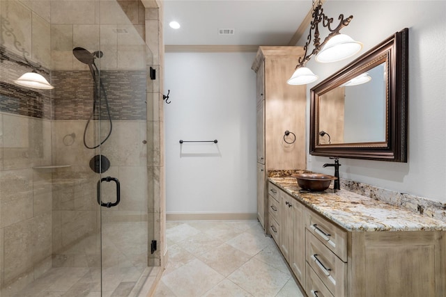 full bath featuring crown molding, vanity, tile patterned floors, baseboards, and a stall shower