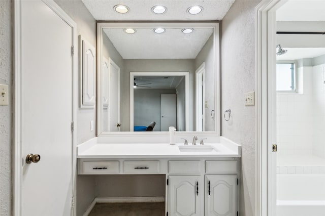 bathroom featuring vanity and a textured wall