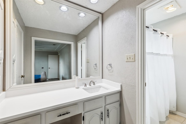 bathroom featuring vanity, tile patterned floors, a textured wall, recessed lighting, and a shower with shower curtain