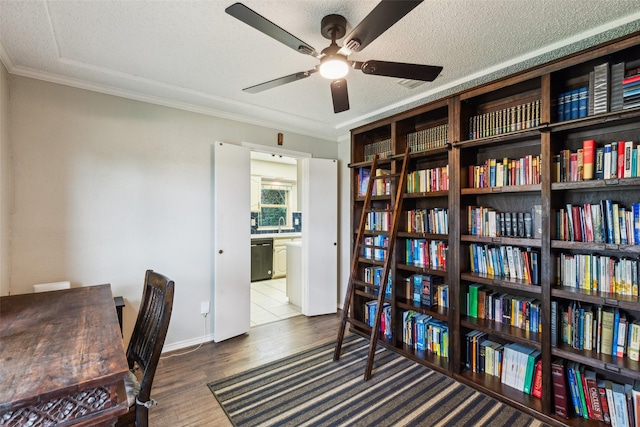 home office with crown molding, baseboards, ceiling fan, and wood finished floors