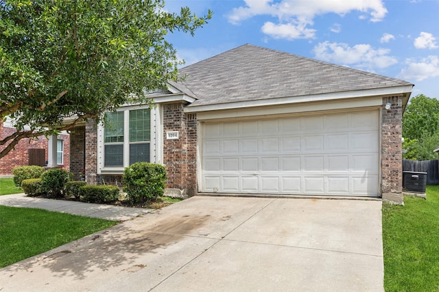 view of front of home featuring concrete driveway, brick siding, a garage, and central air condition unit