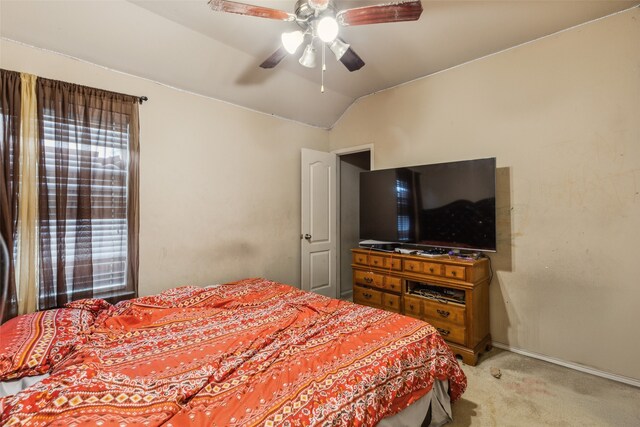 bedroom with light carpet, lofted ceiling, baseboards, and ceiling fan