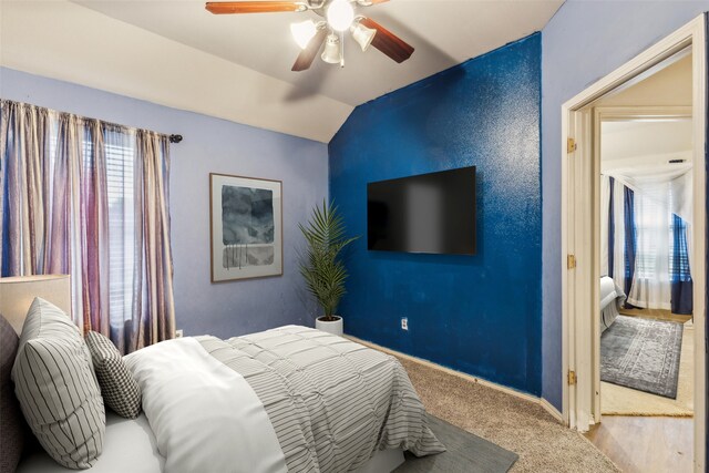 carpeted bedroom featuring lofted ceiling, a ceiling fan, and baseboards