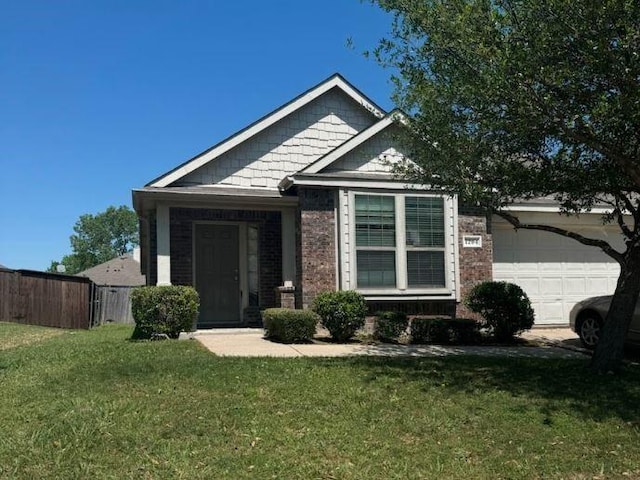 view of front of home with a garage and brick siding