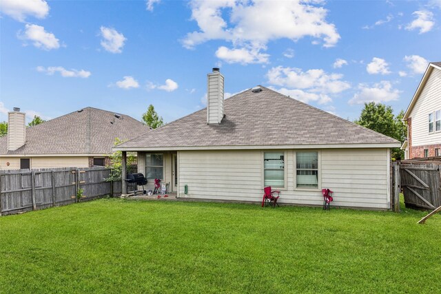 rear view of property with a chimney and a shingled roof