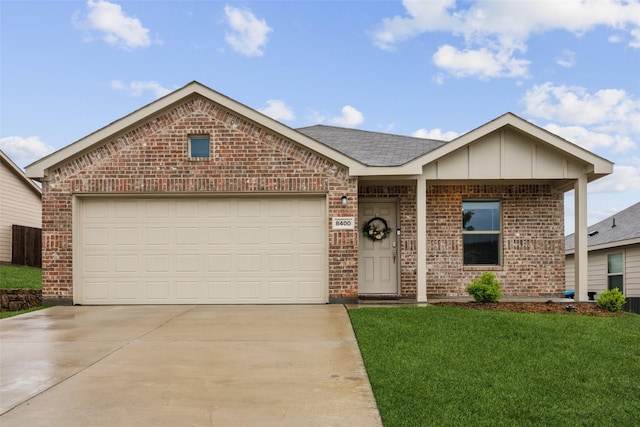 single story home featuring an attached garage, a front lawn, brick siding, board and batten siding, and concrete driveway