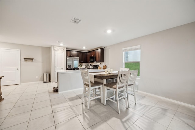 dining room with light tile patterned floors, baseboards, recessed lighting, and visible vents
