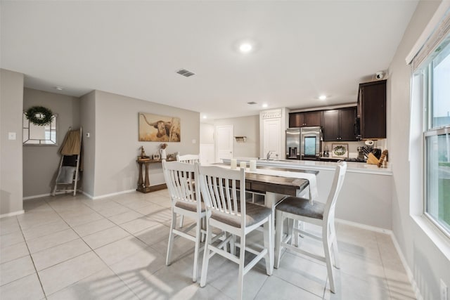dining area featuring recessed lighting, visible vents, plenty of natural light, and light tile patterned floors