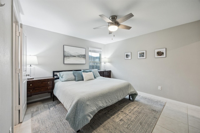 bedroom with baseboards, a ceiling fan, and light tile patterned floors