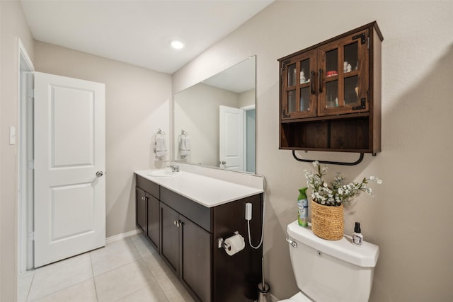 bathroom featuring toilet, tile patterned flooring, and vanity