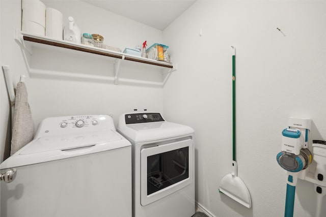 washroom featuring separate washer and dryer and laundry area